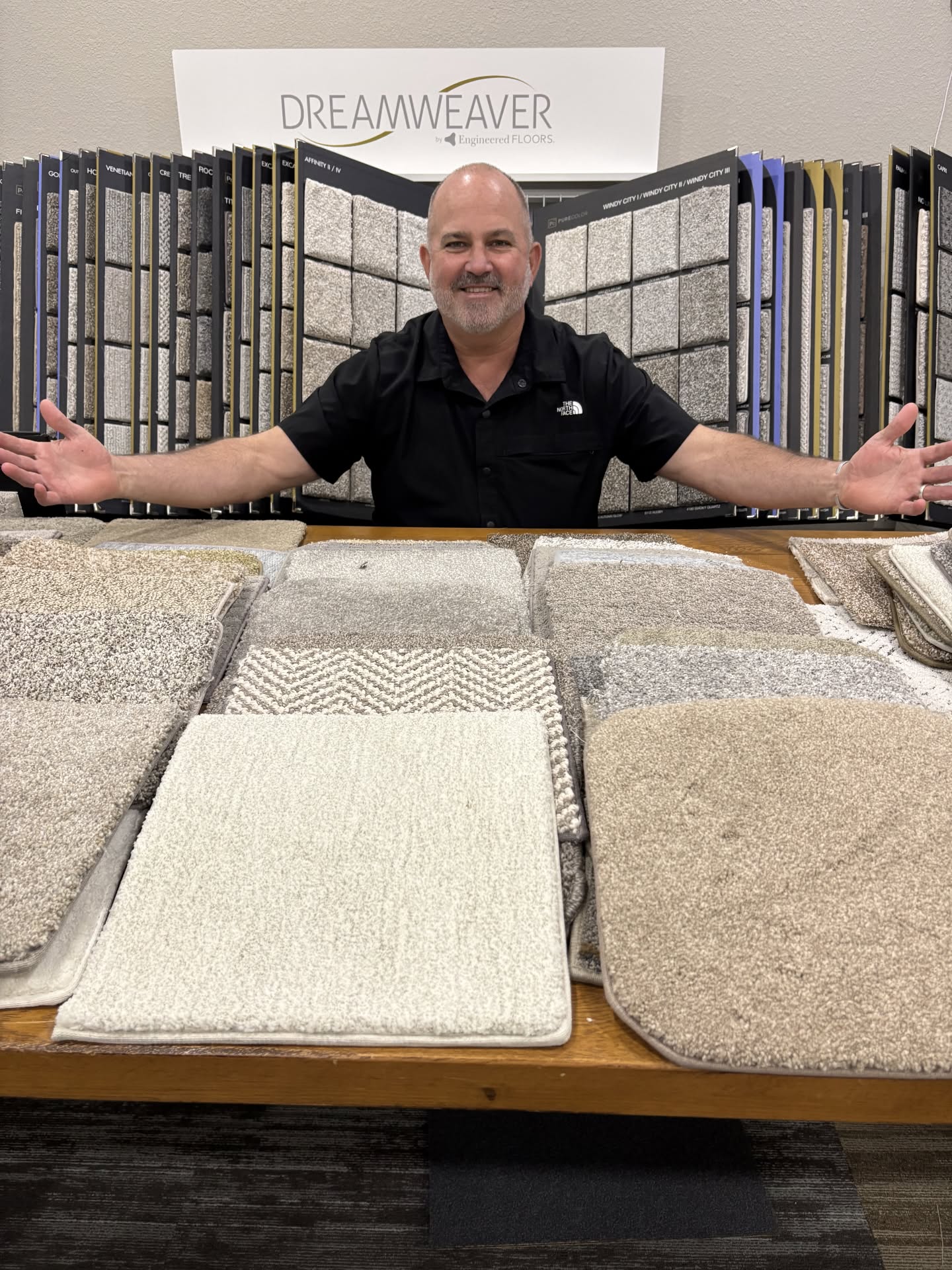 Robert Walker, owner of DFW Flooring Warehouse, holding wood-look tile