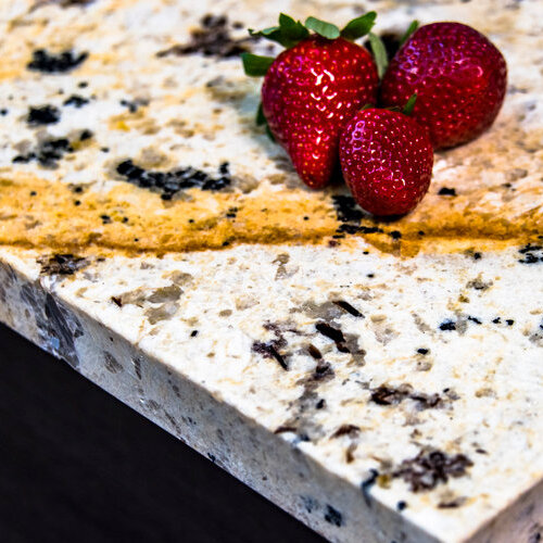 close-up of strawberries on a granite countertop